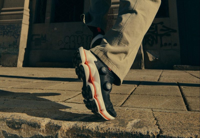 man wearing black sneakers on street