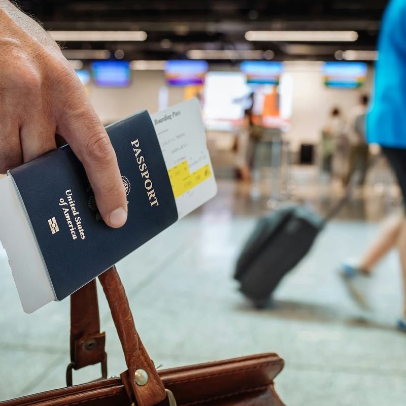 Man holding a passport in his hand at the airport