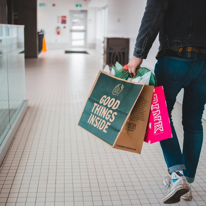 Man walking with shopping bags in hand