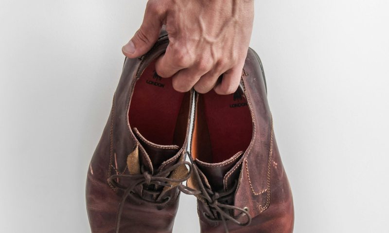 man holding shoes
