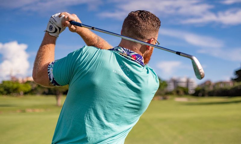 Man playing golf swinging club