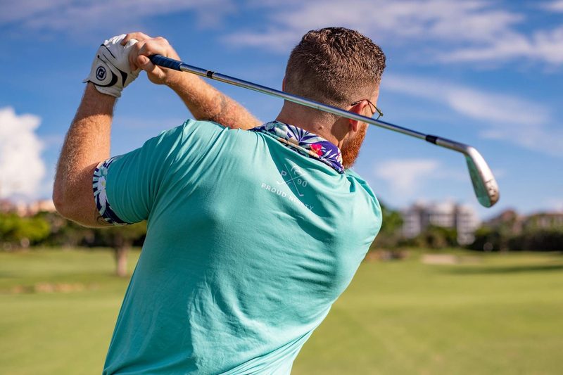 man playing golf swinging club