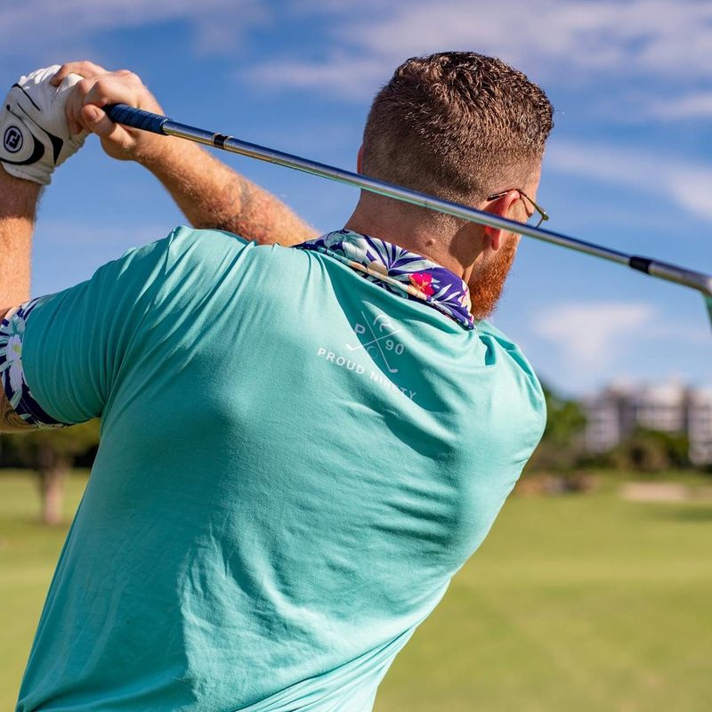Man playing golf swinging club