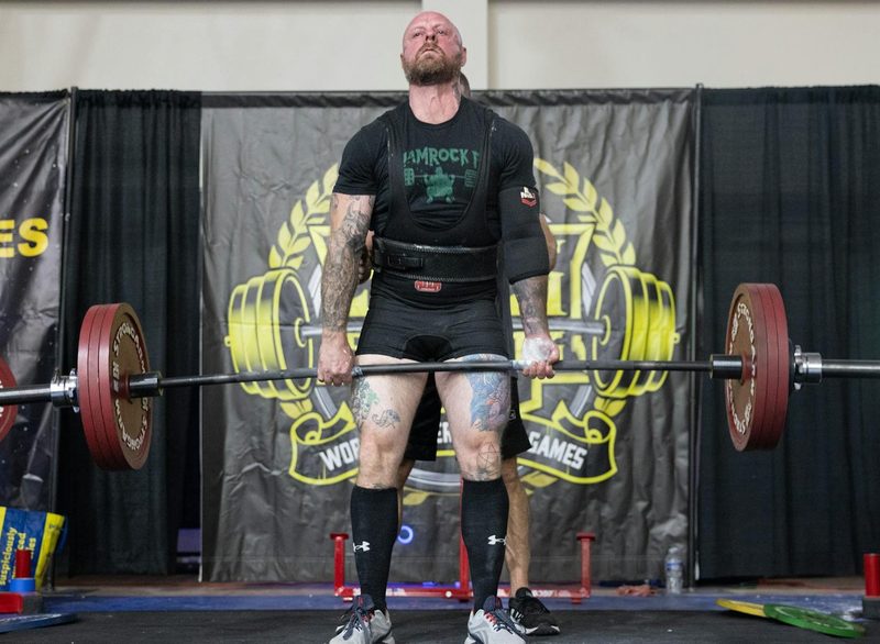 man powerlifting dead lift holding barbell competition