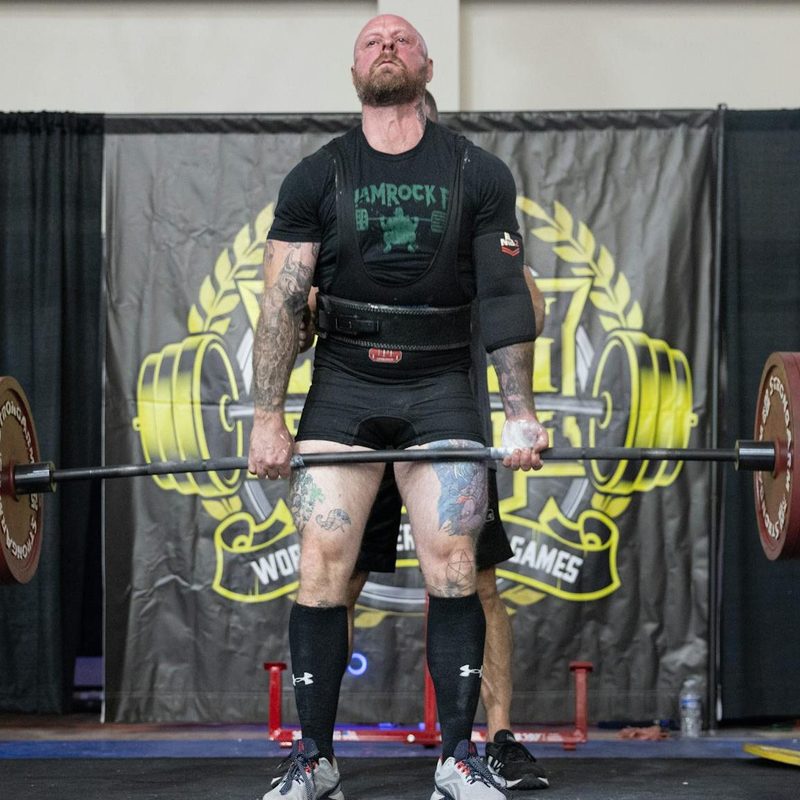 man powerlifting dead lift holding barbell competition