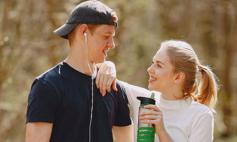 man and woman smiling after workout outside