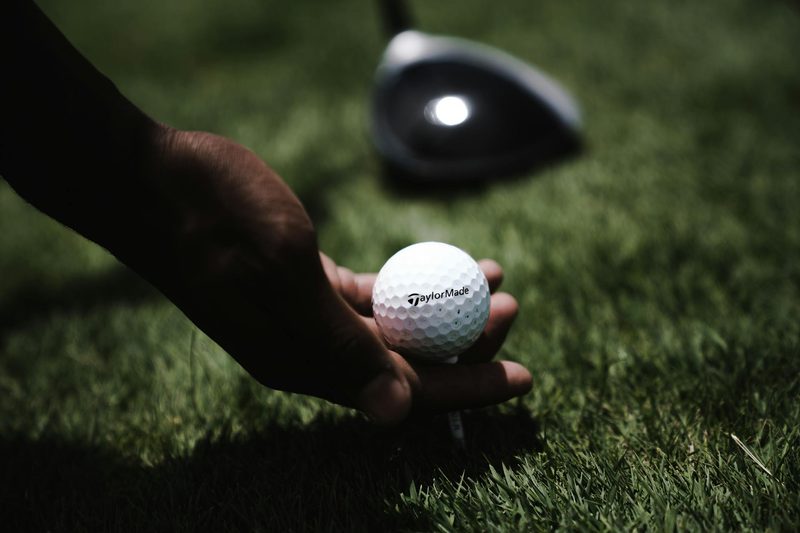 man holding golf ball in hand