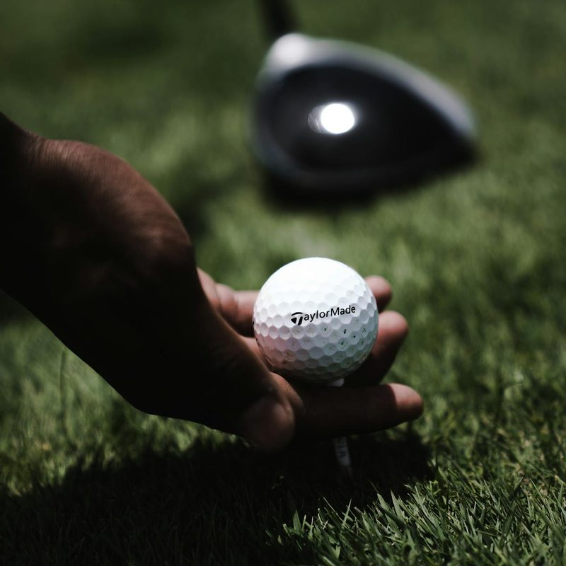 Man holding golf ball in hand