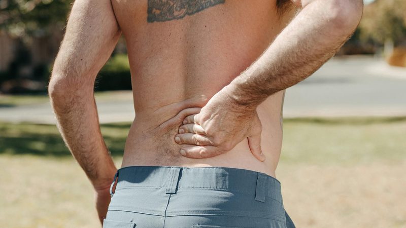 man holding back lower back pain hurting