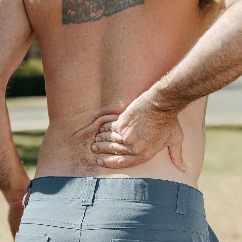 Man holding back lower back pain hurting