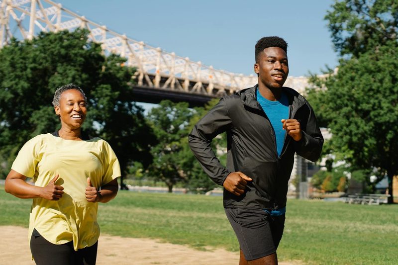 man running with woman outdoors exercise