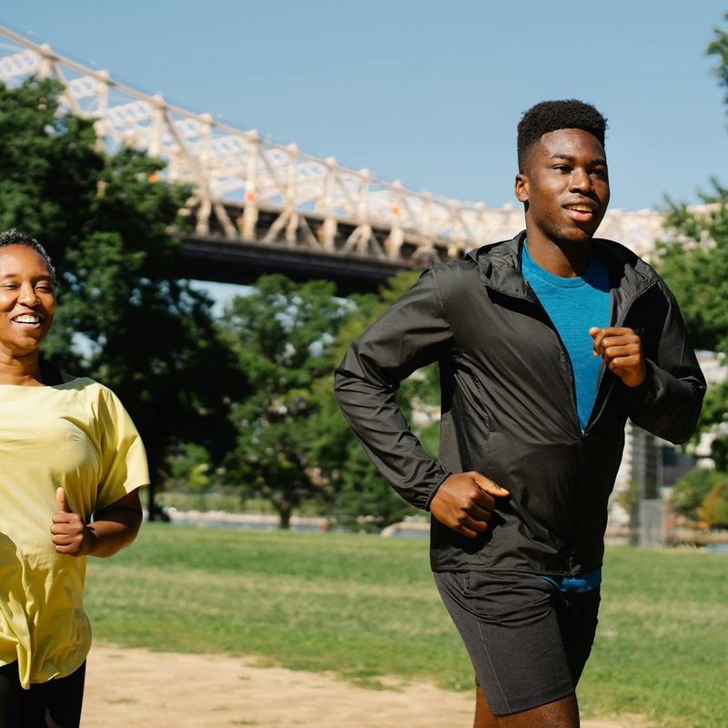 Man running with woman outdoors