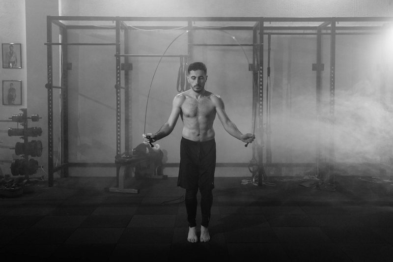 man doing jump rope black and white pic gym exercise