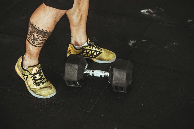 man shoes close up dumbbell on floor