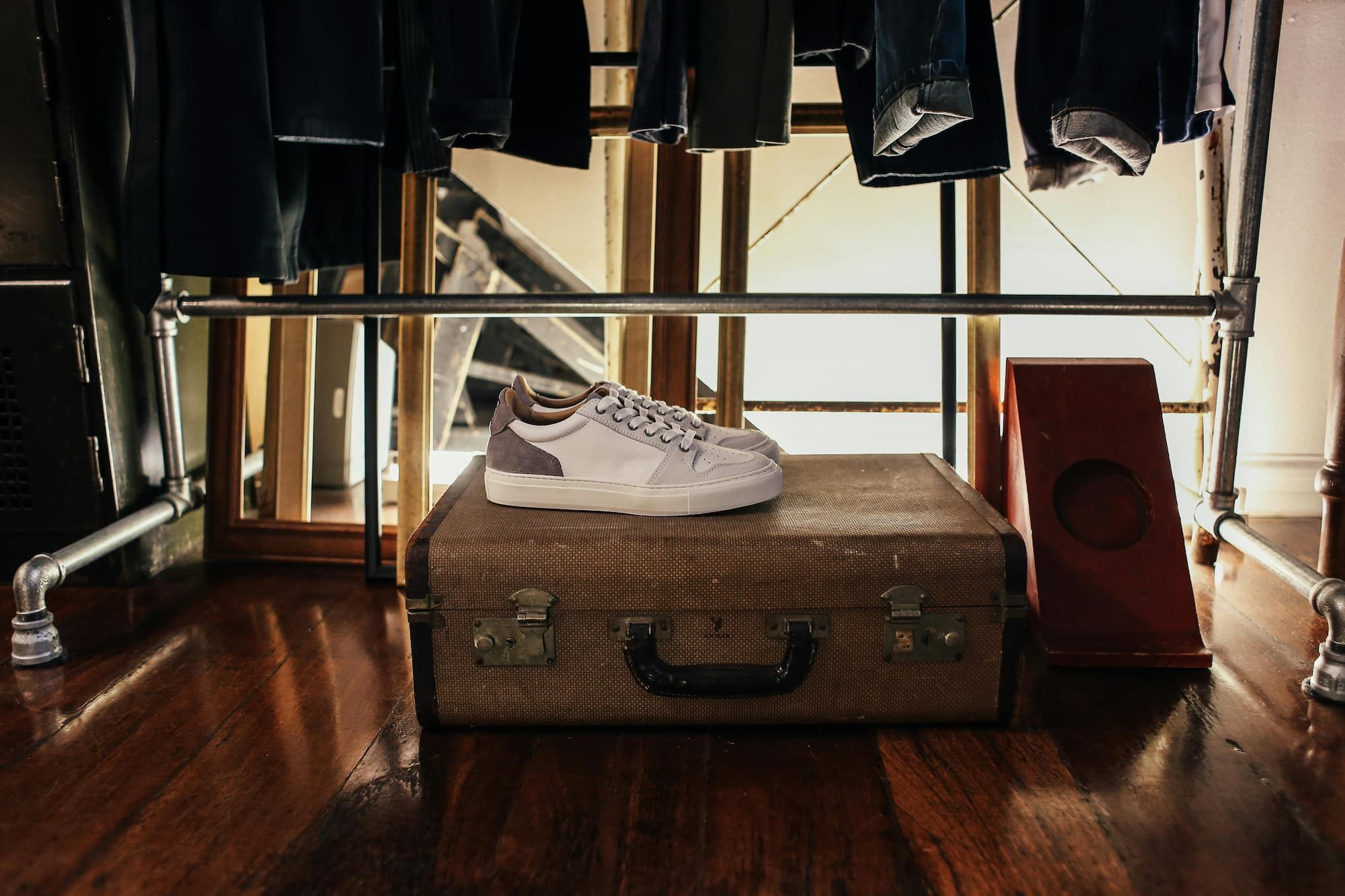 Shoes sitting on top of a suitcase