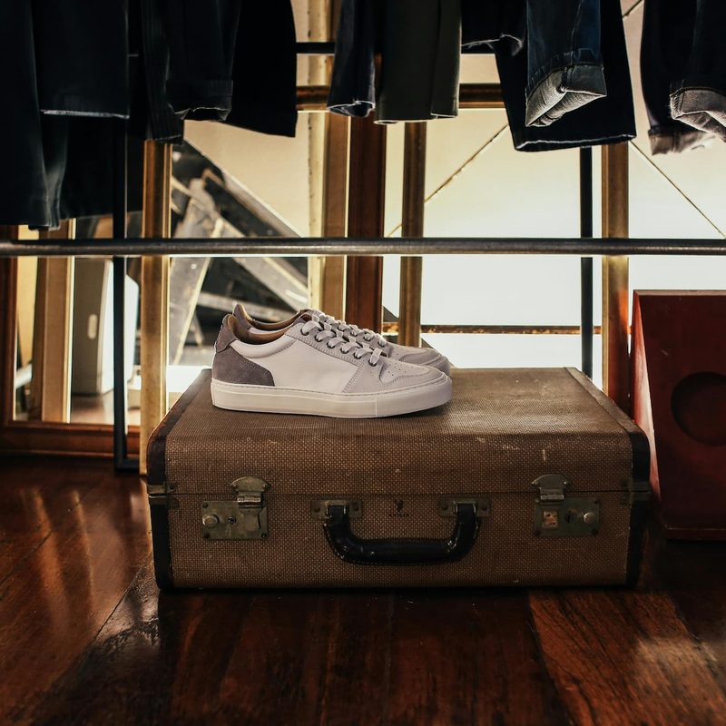 Shoes sitting on top of a suitcase