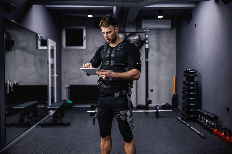 man wearing EMS electrical muscle stimulation suit workout exercise
