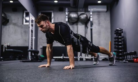 man wearing EMS suit working out push up plank press up.