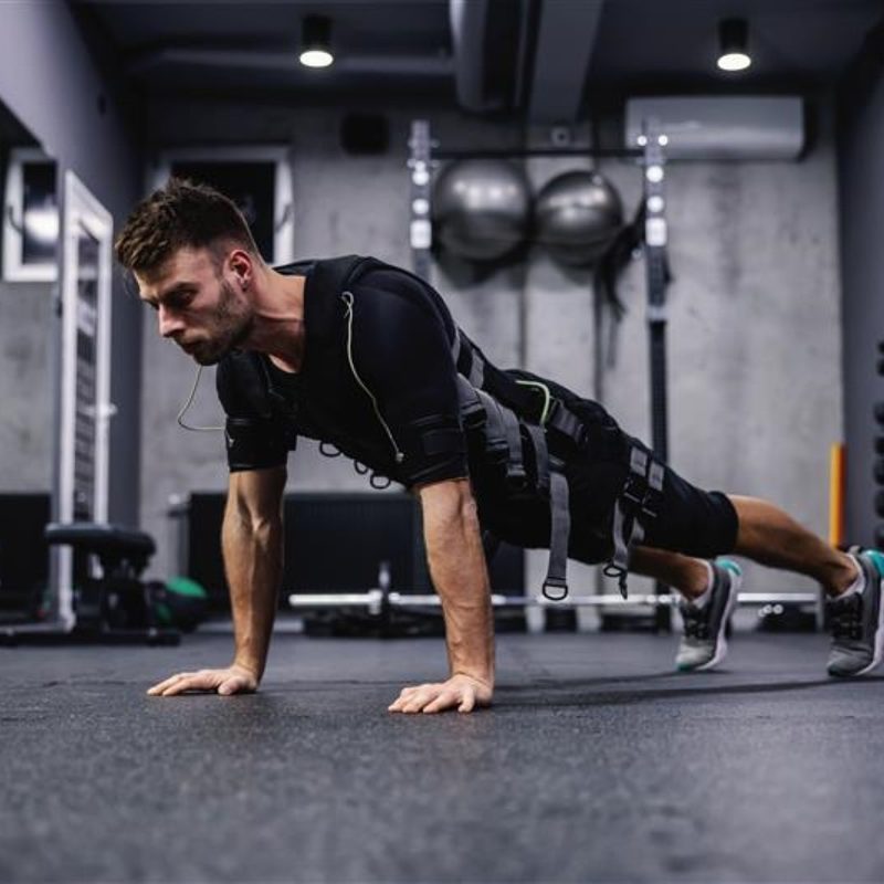 man wearing EMS suit working out push up plank press up.