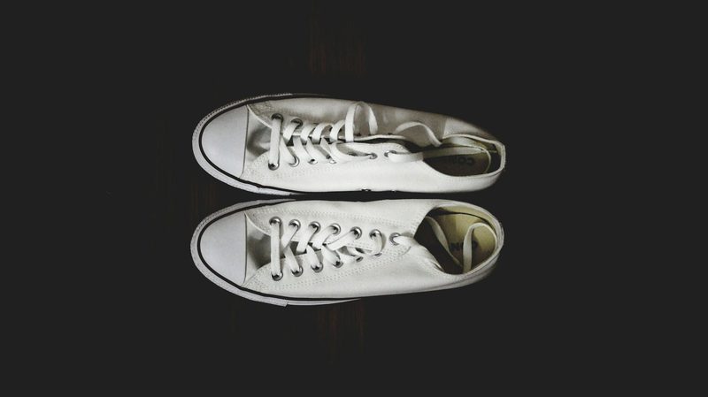 overhead view of white canvas sneakers