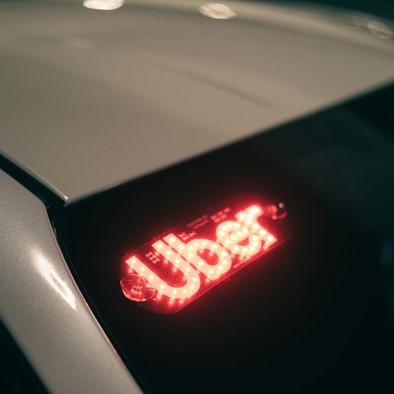 a car with the word "uber" on the windshield