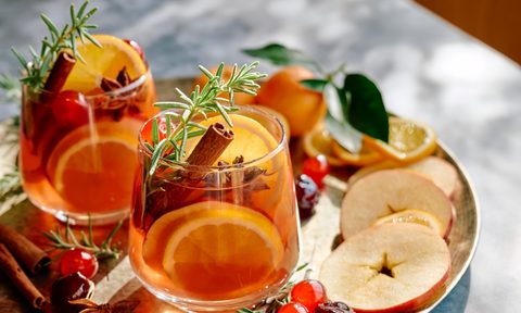 Mulled wine or christmas sangria with aromatic spices, apple, cherry and citrus fruits. Traditional Christmas festive warming spiced drink with orange, berry, cinnamon, cardamom and anise.