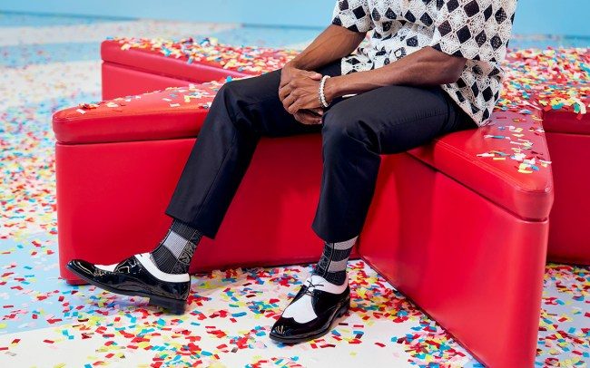 model wearing stacy adams shoes on red couch