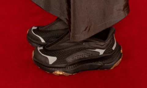 man wearing black hoka sneakers