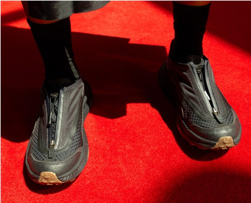 man wearing black hoka sneakers