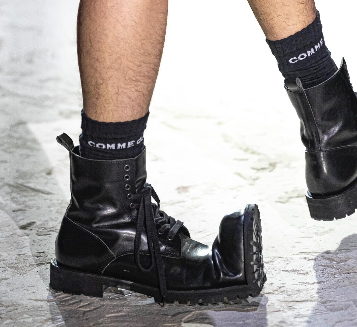 model wearing comme des garcons boots on runway