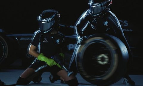 two people holding tires and pit stop gear