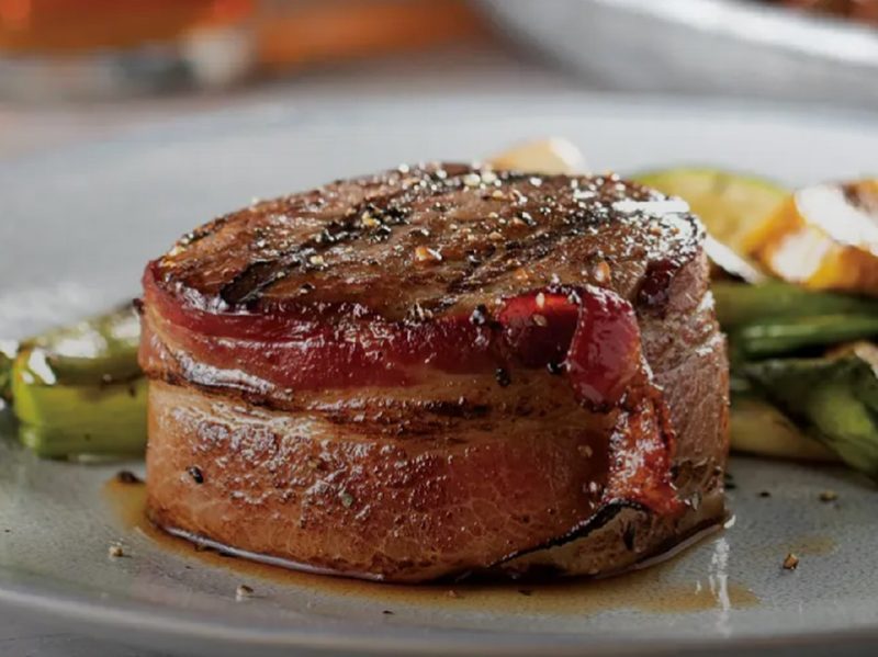 The Bacon-Wrapped Filet Mignon of Omaha Steak's Omaha Steaks Sampler on a plate.