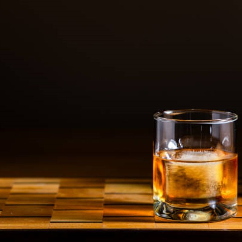 Whiskey in a glass with an ice cube