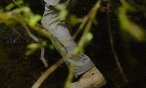 man wearing timberland boot in forest