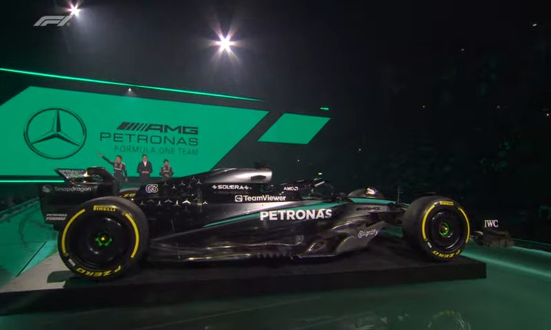 F1 75 Live - Mercedes 2025 livery with drivers George Russell and Kimi Antonelli, and Team Principal Toto Wolff in the background.