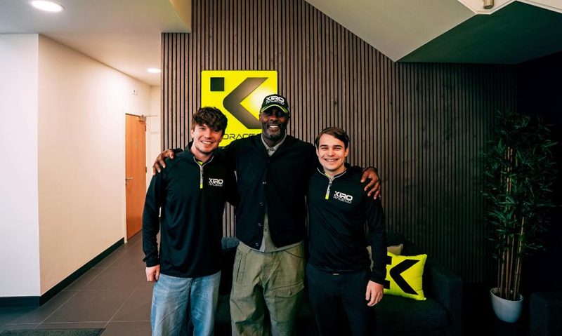 Idris Elba with two Formula E race car drivers.