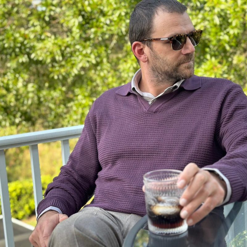 Man in burgundy sweater polo