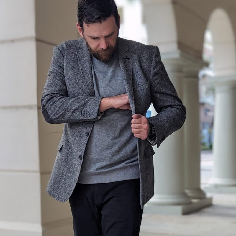 Man in gray tweed and jeans