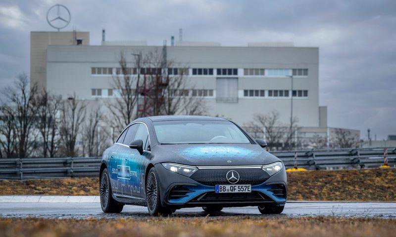 Mercedes solid state EV battery test car parked on a road by borwn grass.