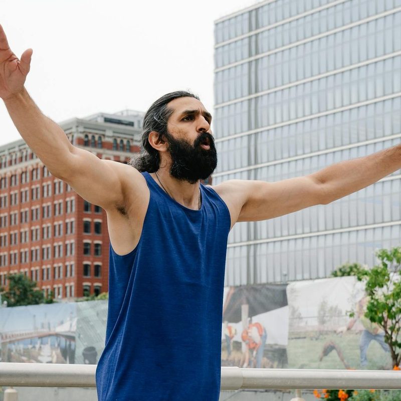 Man doing jumping jacks workout