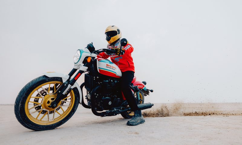 Royal Enfield Shotgun 650 limited edition left front three-quarter view of the riding sliding the bike in the desert.