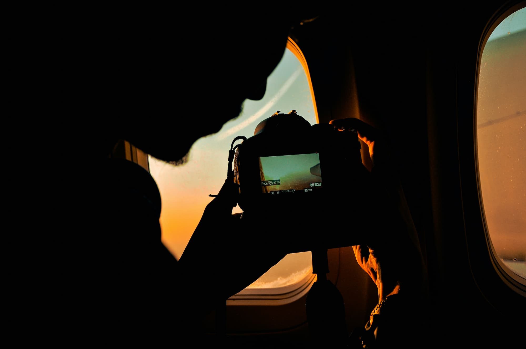 a person taking a picture out of an airplane window