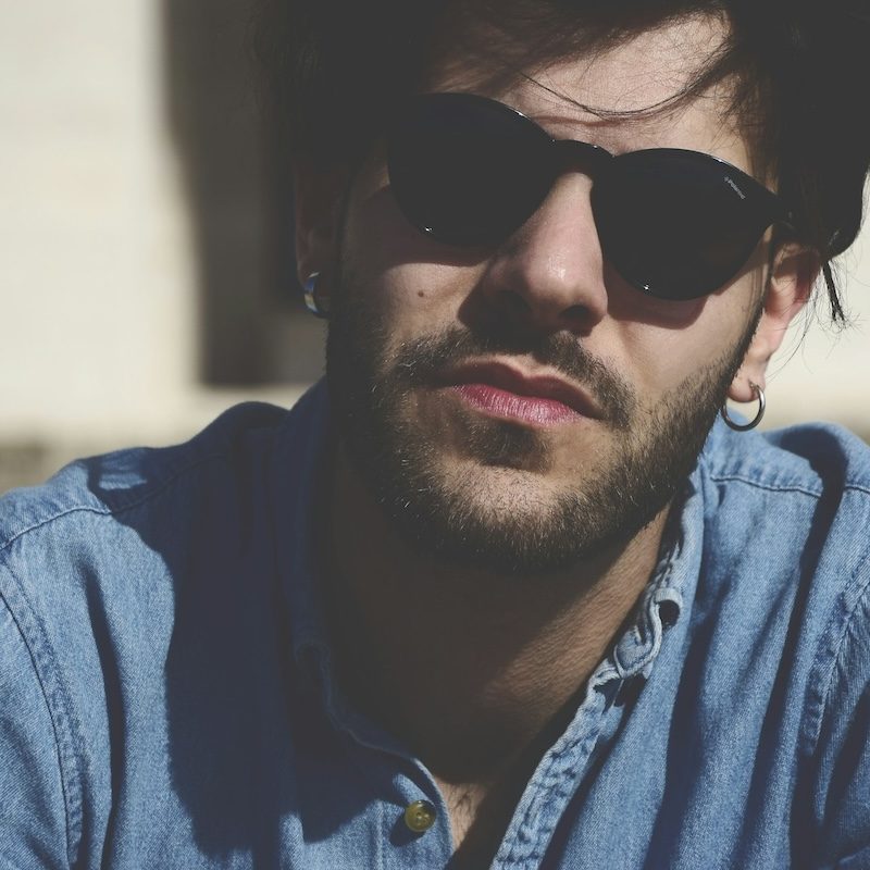 Man staring into camera with great hair and sunglasses