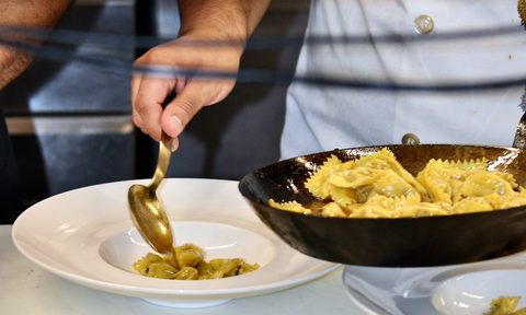 Plating pasta at Barolo Grill.