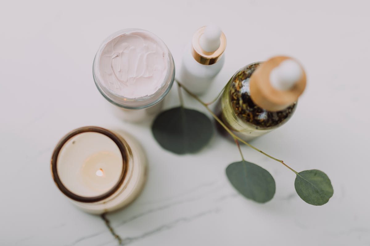 A candle and two skincare products
