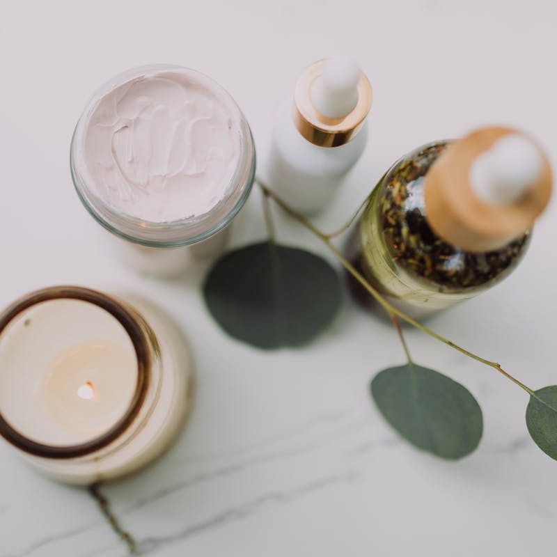 A candle and two skincare products