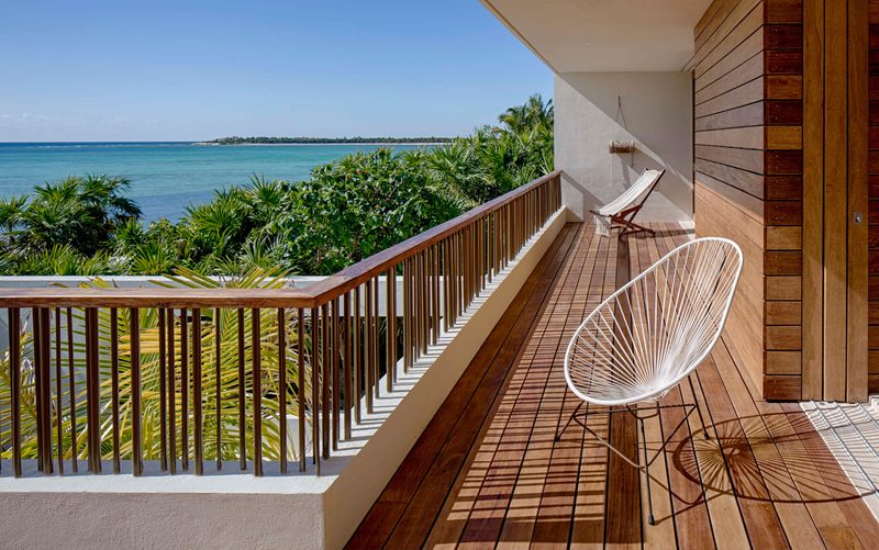 two chairs on a balcony overlooking the ocean