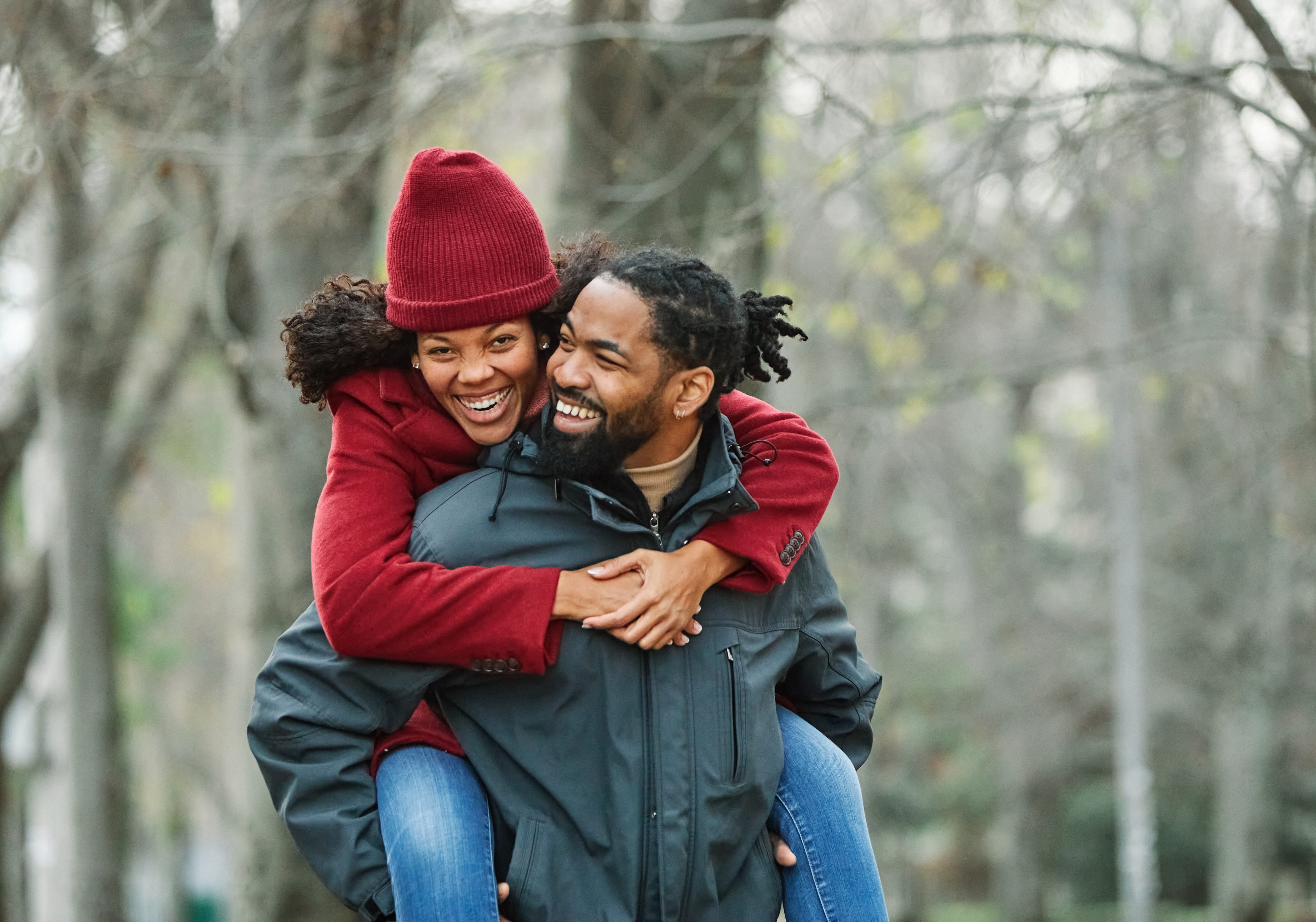 Young couple having fun outdoors in a park, healthy active lifestyle, bonding and embracing concept