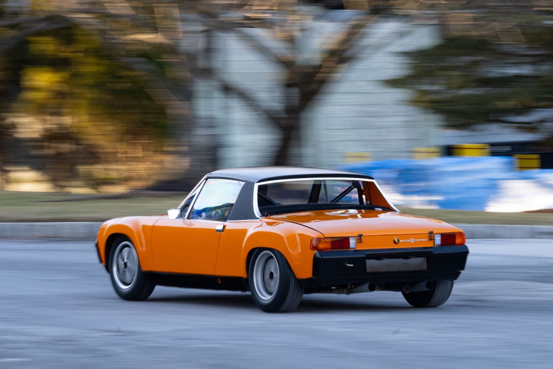 Rear view of a 914/6 GT driving down a street