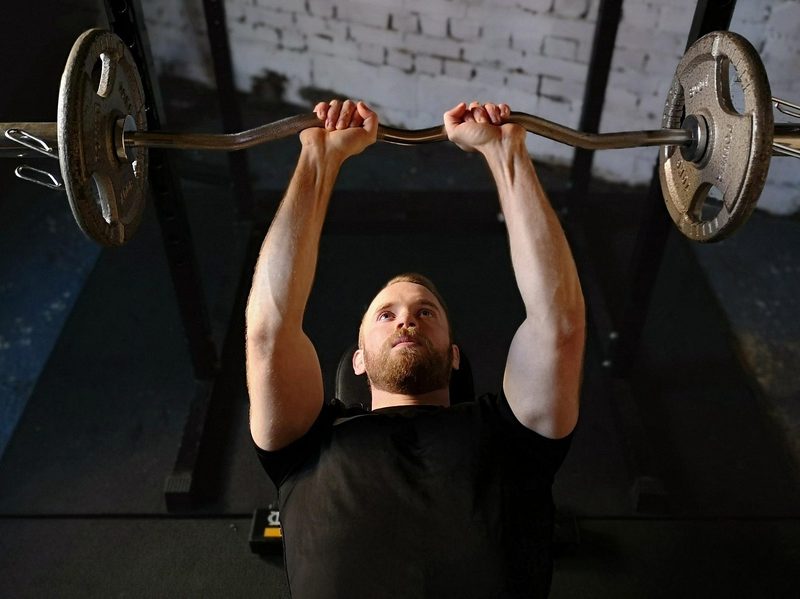 man lifting barbell bench press lift